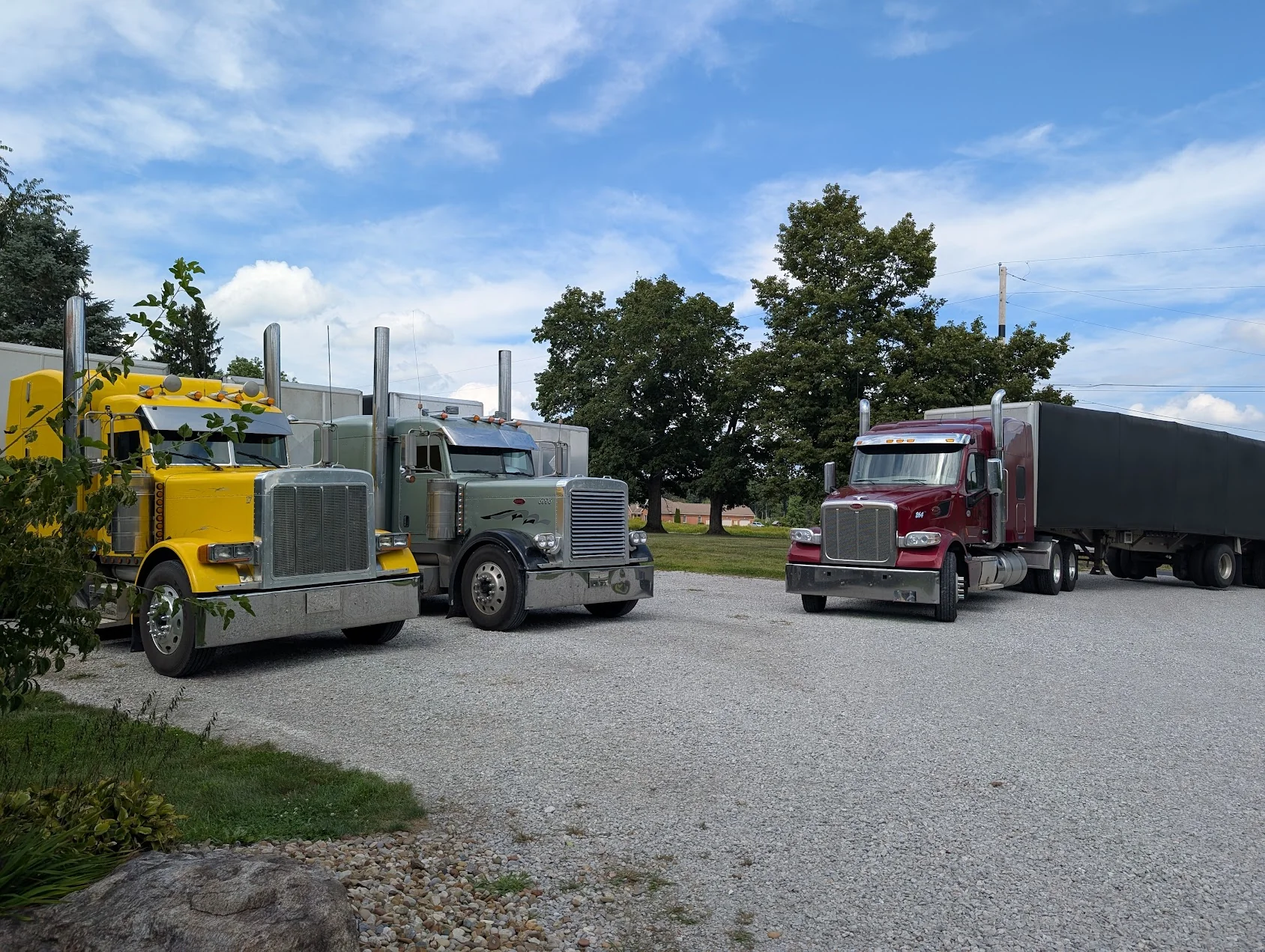 Nightfall Express fleet — three Peterbilt semi trucks parked at the Ashland, OH yard